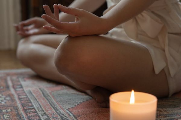 Person meditating in a calm yoga pose, surrounded by peaceful light.